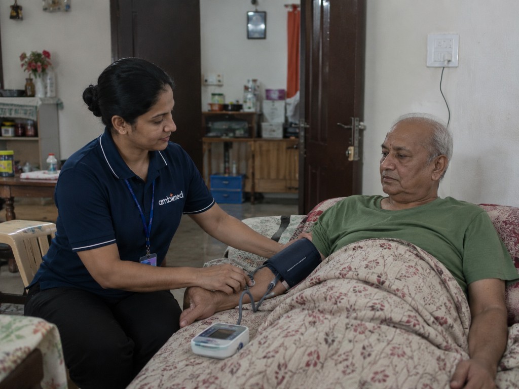 Ambimed home nurse checking blood pressure for an elderly patient at home